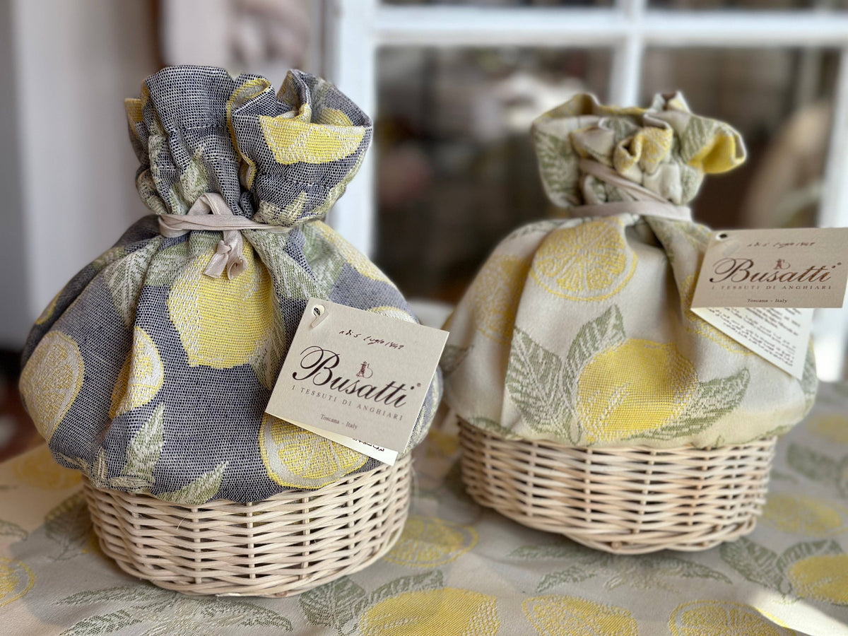 Two wrapped items in wicker baskets with lemon-themed packaging and Busatti labels.